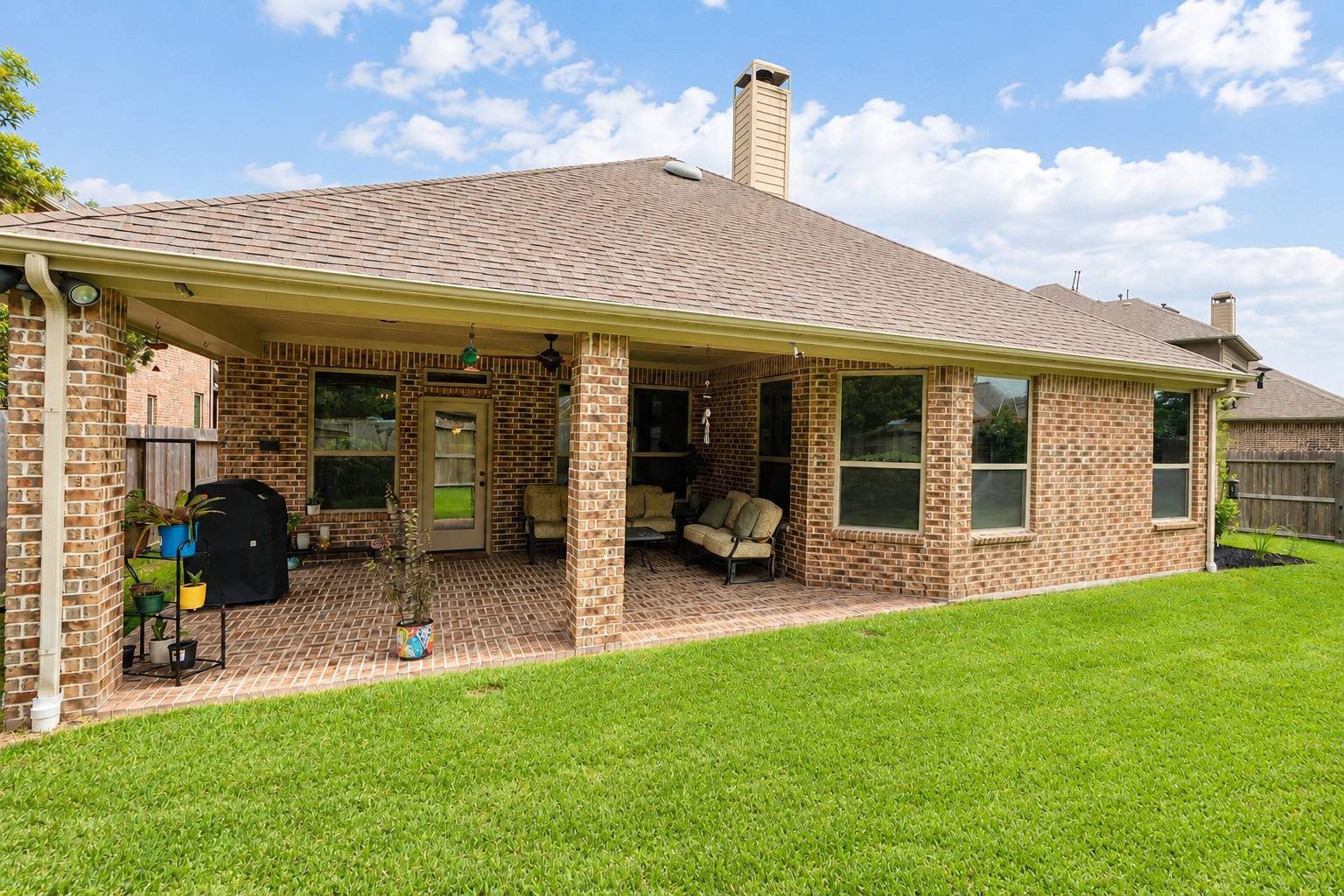 2326 Hamilton Pool Lane Friendswood, TX 77546 - Photo 41 of 49 a backyard of a house with yard table and chairs