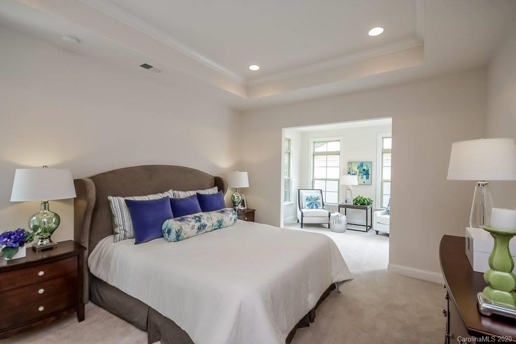 2018 New Style Way, Unit 5 Tega Cay, SC 29708 - Photo 32 of 36 a bedroom with a bed and lamp with window