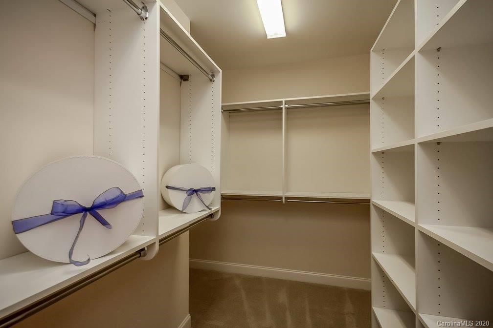 2018 New Style Way, Unit 5 Tega Cay, SC 29708 - Photo 33 of 36 a picture of a room with racks on the wall