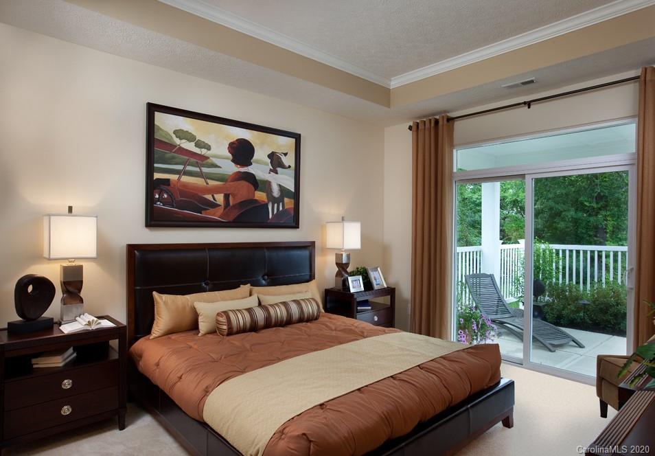 2018 New Style Way, Unit 5 Tega Cay, SC 29708 - Photo 34 of 36 a bedroom with a bed a couch and a window