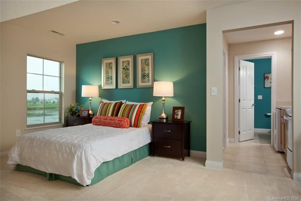 2018 New Style Way, Unit 5 Tega Cay, SC 29708 - Photo 8 of 36 a bedroom with a bed and window