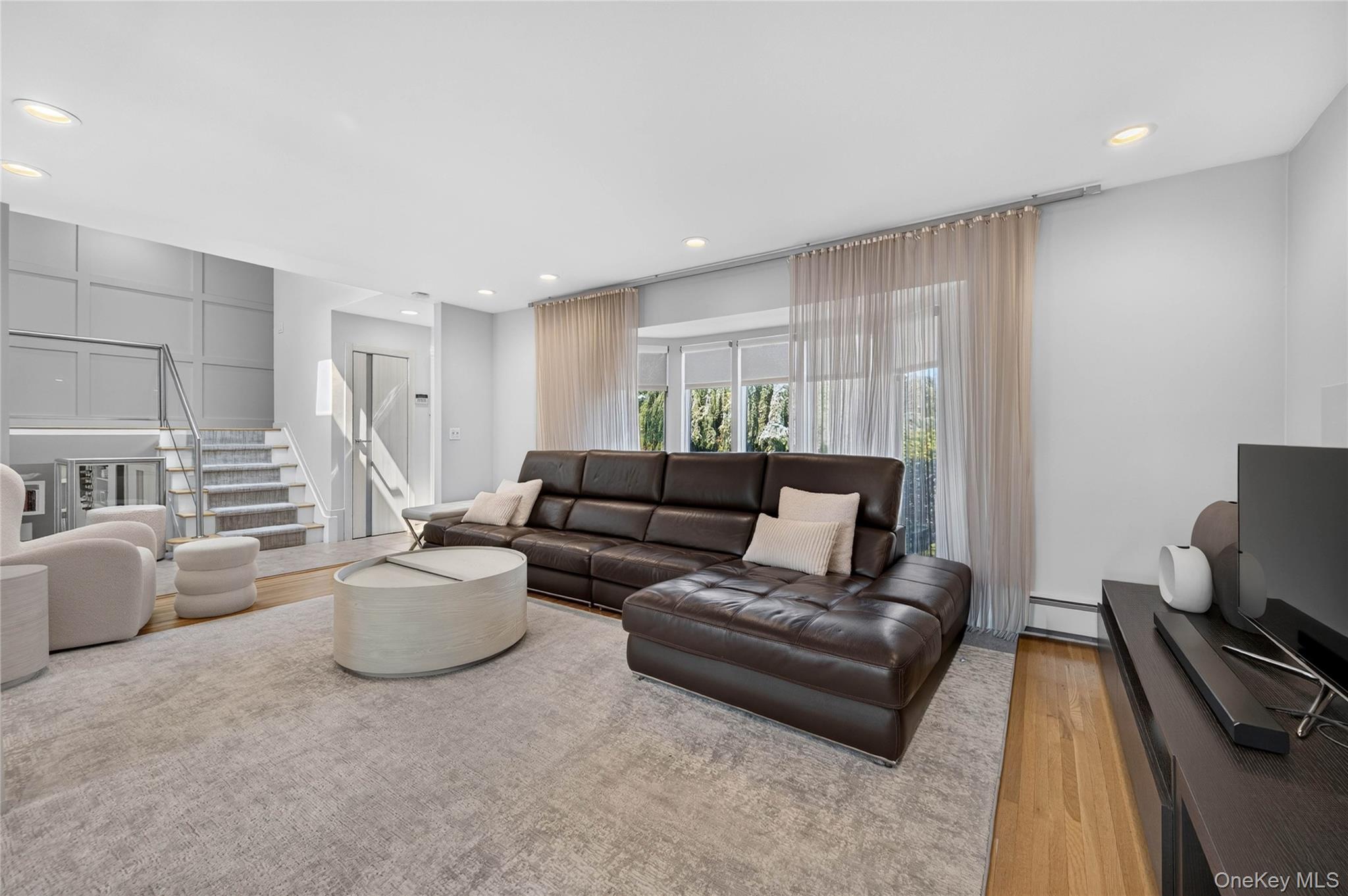 11 Sunbeam Road Syosset, NY 11791 - Photo 7 of 28 Open-concept living area featuring light wood-finish flooring and recessed lighting