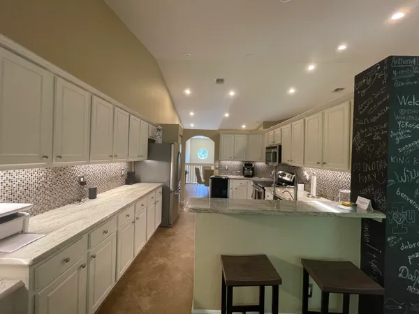 a large kitchen with lots of table and chairs