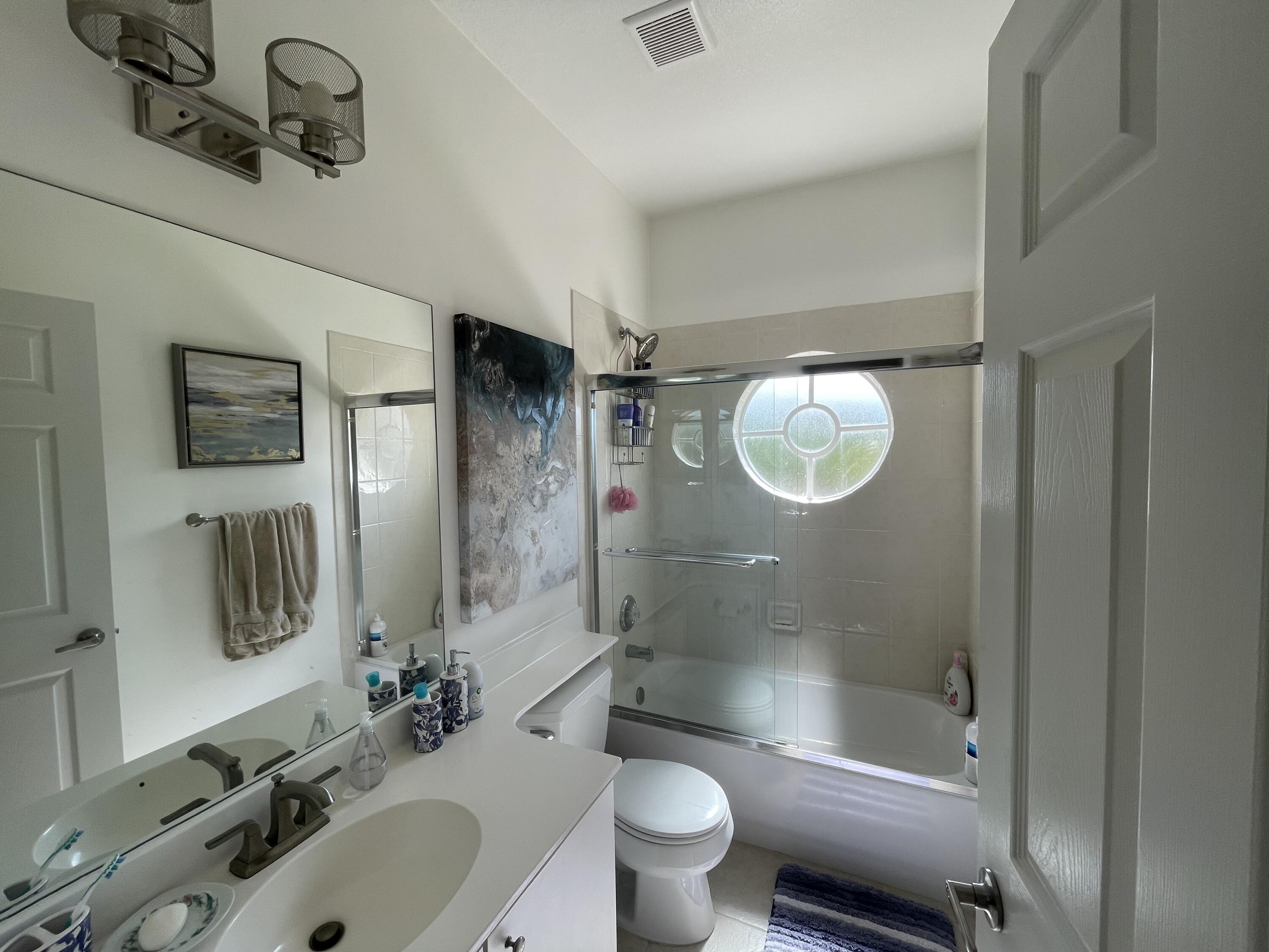 16075 Sims Road, Unit 203 Delray Beach, FL 33484 - Photo 11 of 20 a bathroom with a sink a toilet and shower