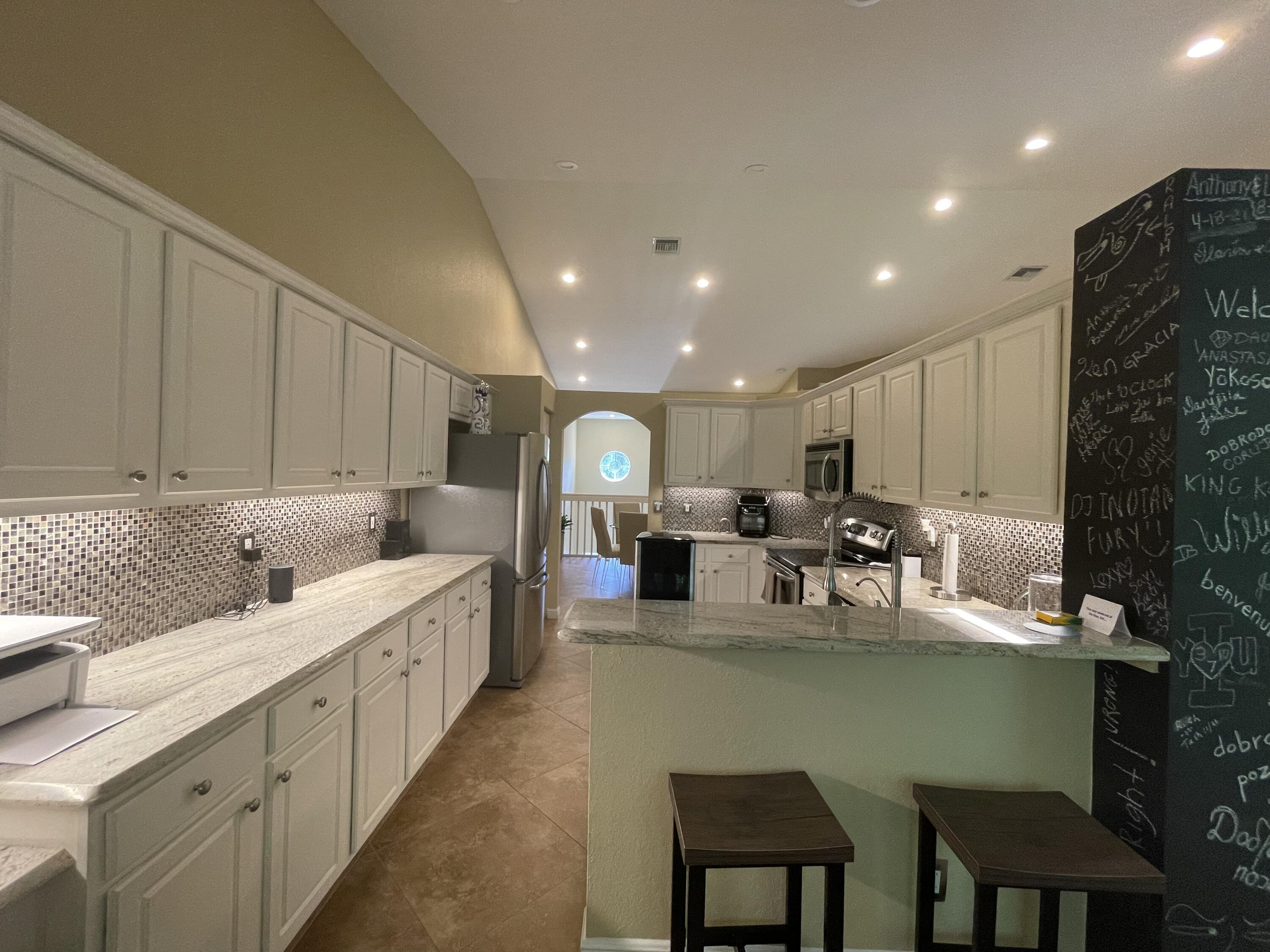16075 Sims Road, Unit 203 Delray Beach, FL 33484 - Photo 12 of 20 a large kitchen with lots of table and chairs