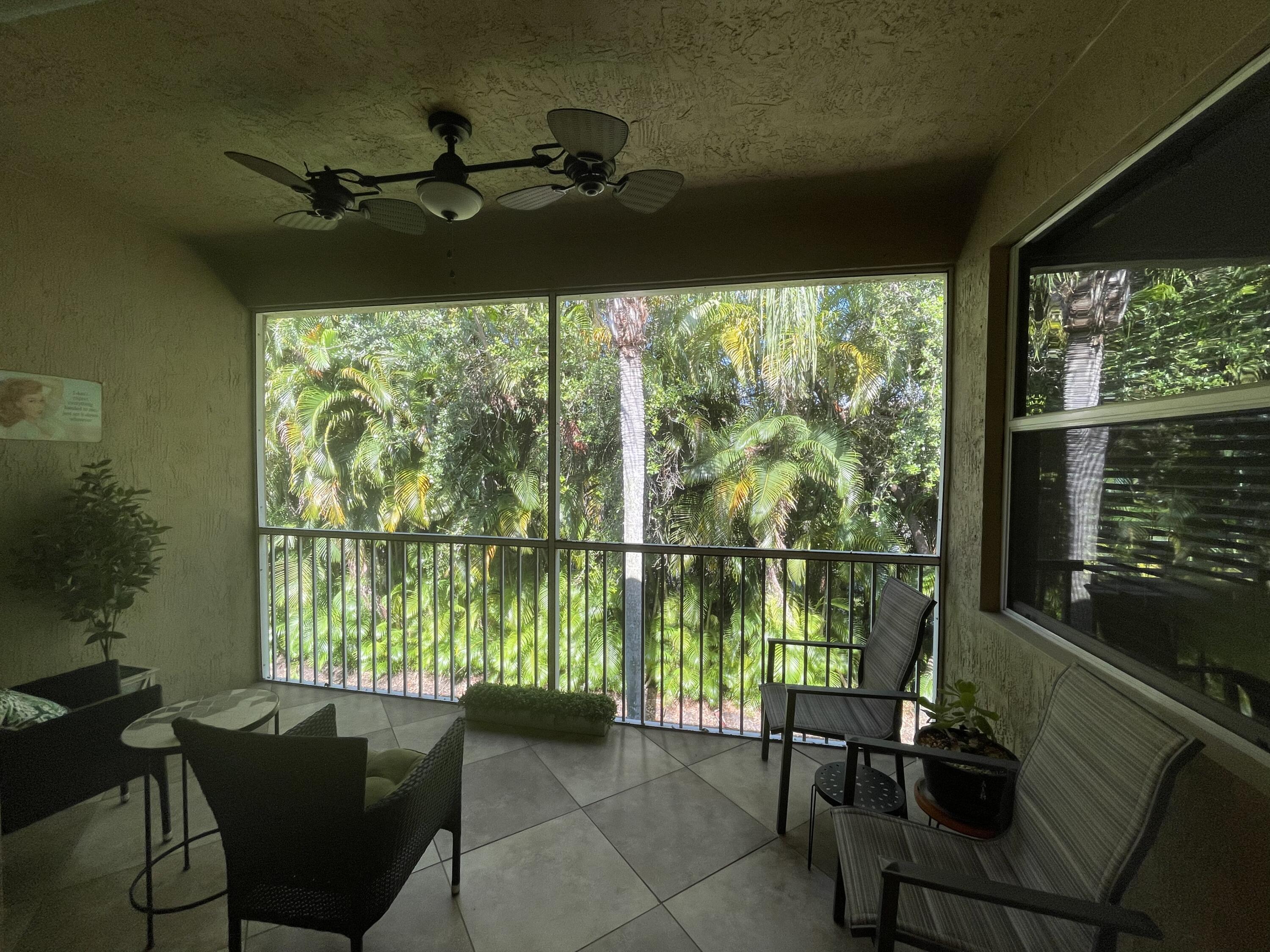 16075 Sims Road, Unit 203 Delray Beach, FL 33484 - Photo 13 of 20 a living room with furniture and a floor to ceiling window