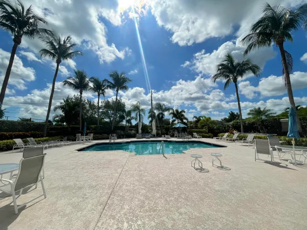 a view of swimming pool with outdoor seating and plants