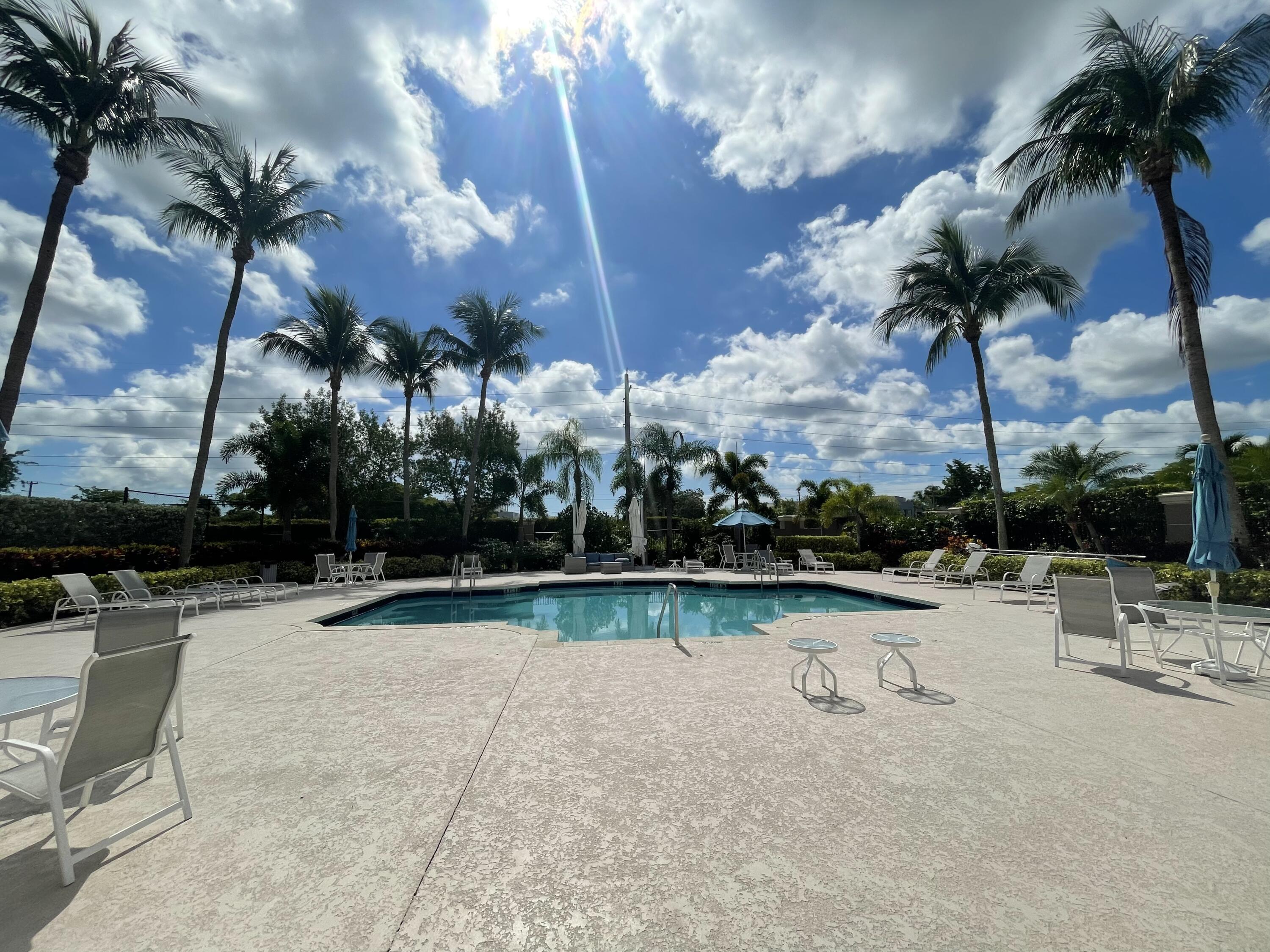 16075 Sims Road, Unit 203 Delray Beach, FL 33484 - Photo 16 of 20 a view of swimming pool with outdoor seating and plants