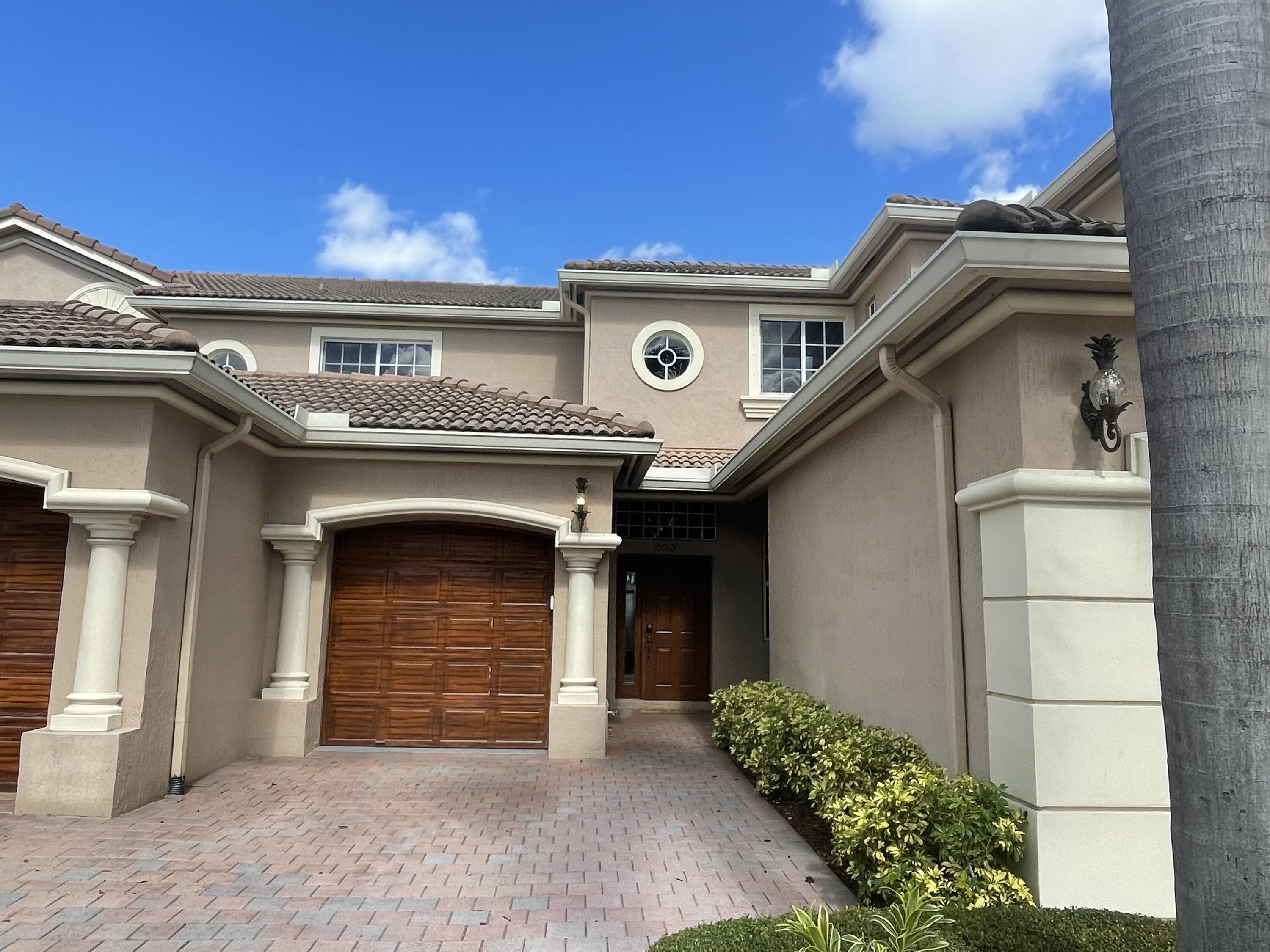 16075 Sims Road, Unit 203 Delray Beach, FL 33484 - Photo 20 of 20 a front view of a house with a garage