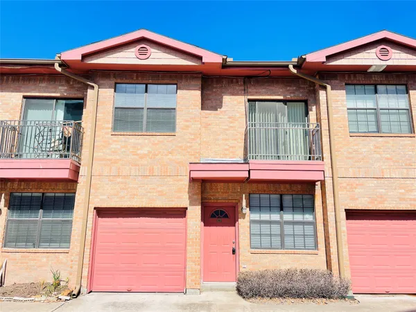 an empty room with wooden floor chandelier fan and windows