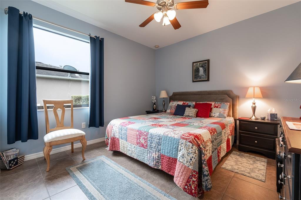 15969 Southwest 14th Avenue Road Ocala, FL 34473 - Photo 31 of 46 a bedroom with a bed and a chandelier