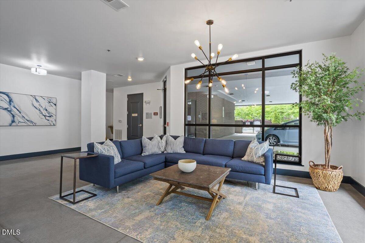 1300 St Marys Street, Unit 207 Raleigh, NC 27605 - Photo 26 of 31 a living room with furniture and a large window