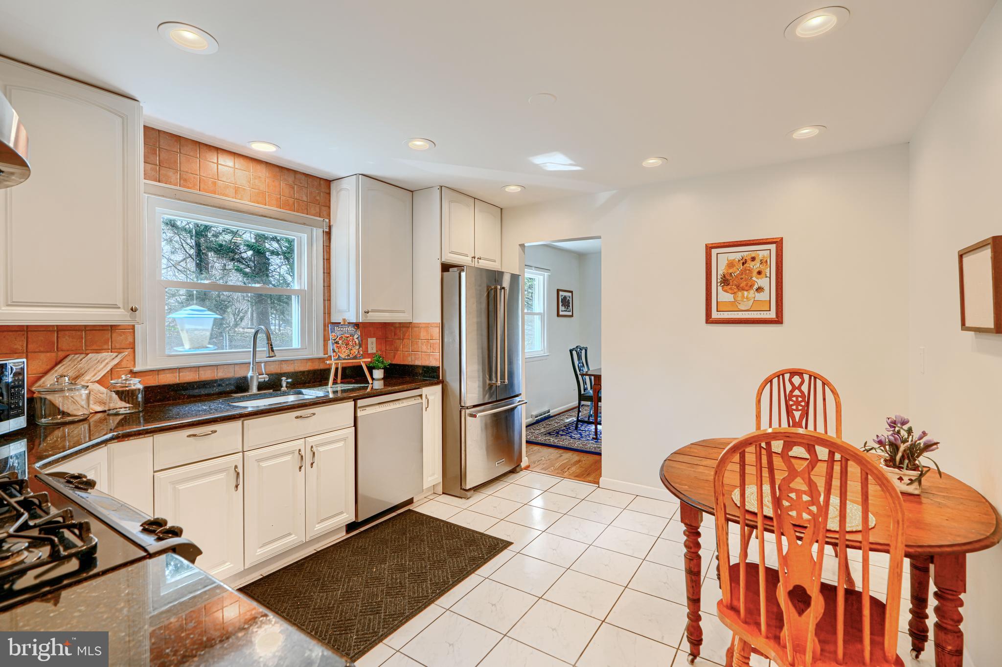 1202 Vermont Road Bel Air, MD 21014 - Photo 17 of 66 a kitchen with stainless steel appliances granite countertop a sink a stove a refrigerator cabinets and a dining table with wooden floor