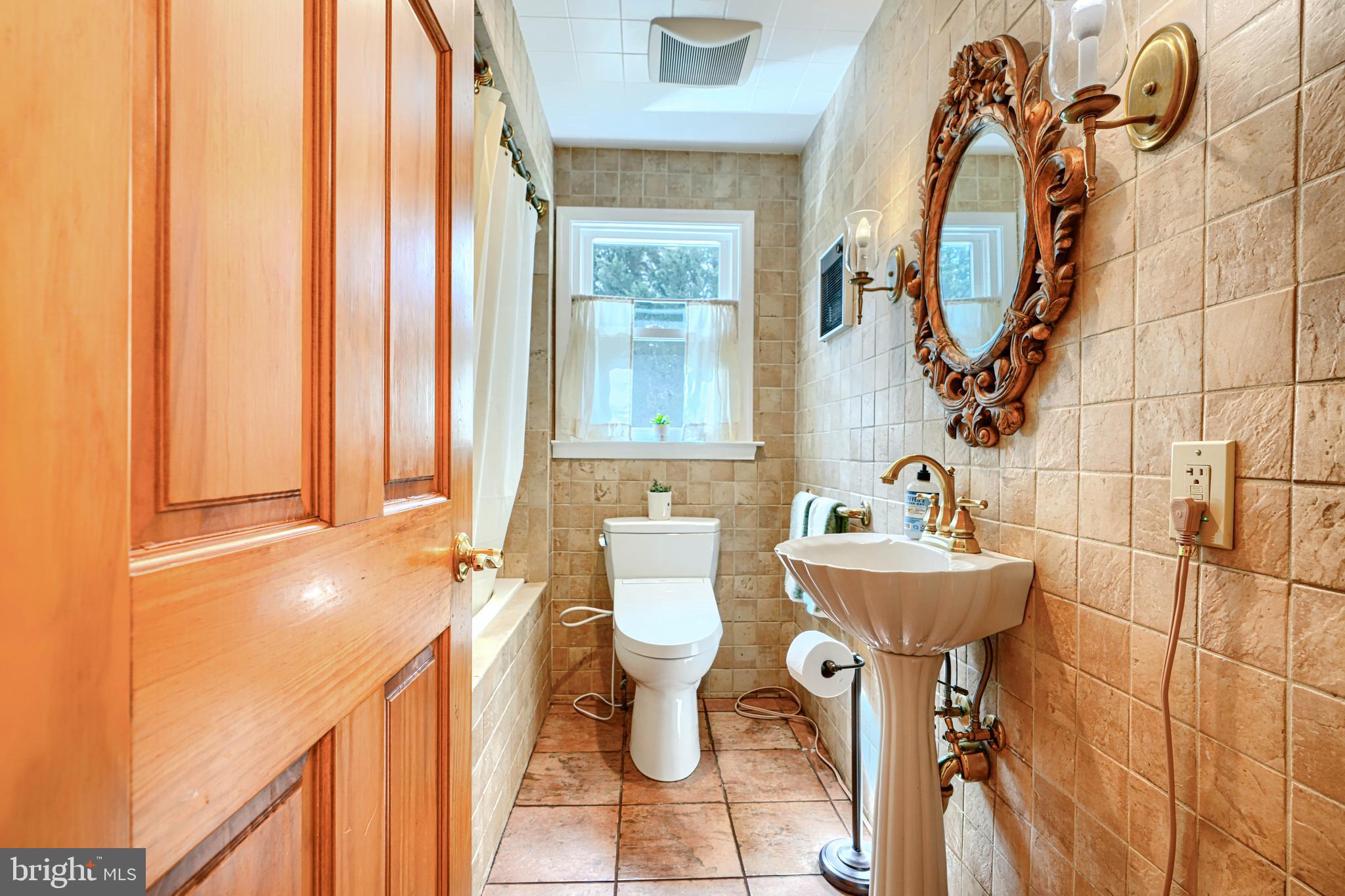 1202 Vermont Road Bel Air, MD 21014 - Photo 19 of 66 a bathroom with a sink and mirror with bathtub