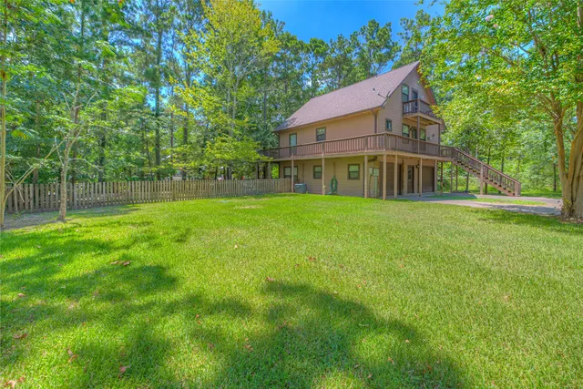a view of yard with swimming pool and green space