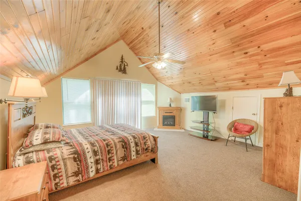 a spacious bedroom with a bed and a chandelier