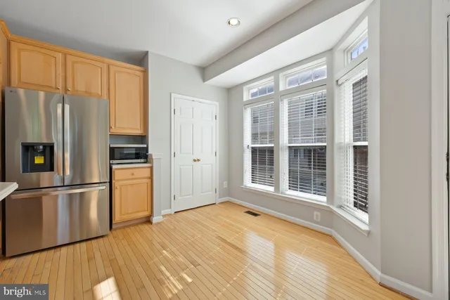 a view of empty room with wooden floor and fireplace