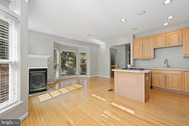 a kitchen with a refrigerator a sink and a stove top oven