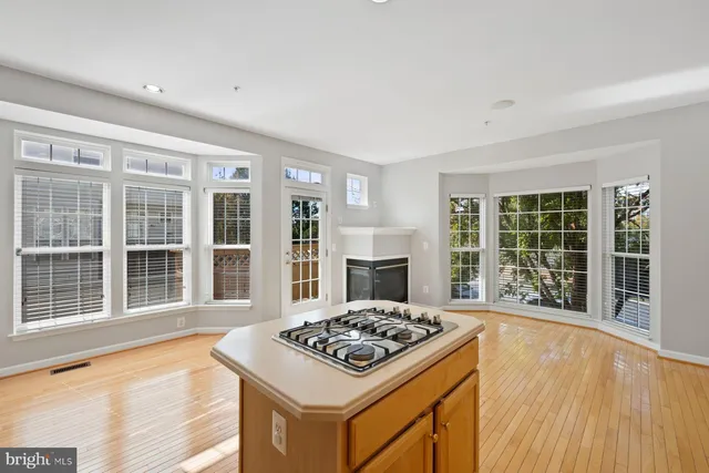 a kitchen with a refrigerator a stove top oven and cabinets