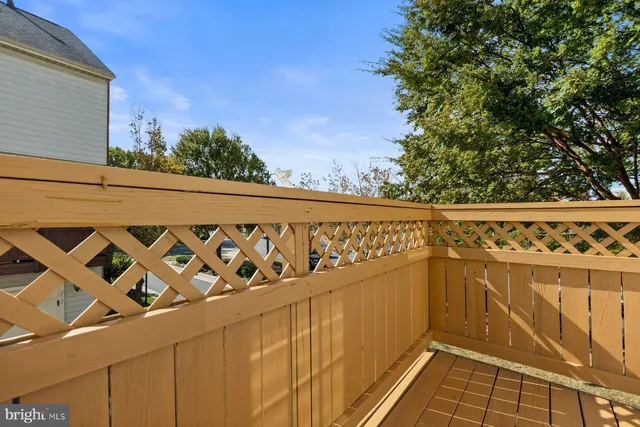 a kitchen with granite countertop a stove a sink dishwasher and a refrigerator with wooden floor