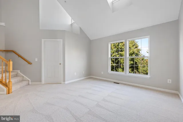 a view of a brick house with wooden fence