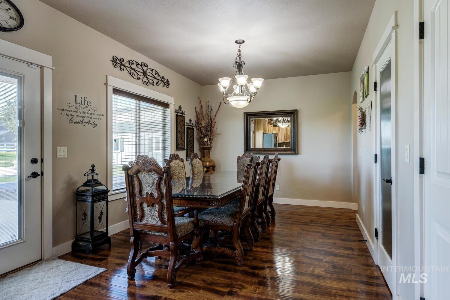 22757 Rosicky Way Caldwell, ID 83607 - Photo 17 of 50 Dining room with dark wood finished floors and a chandelier
