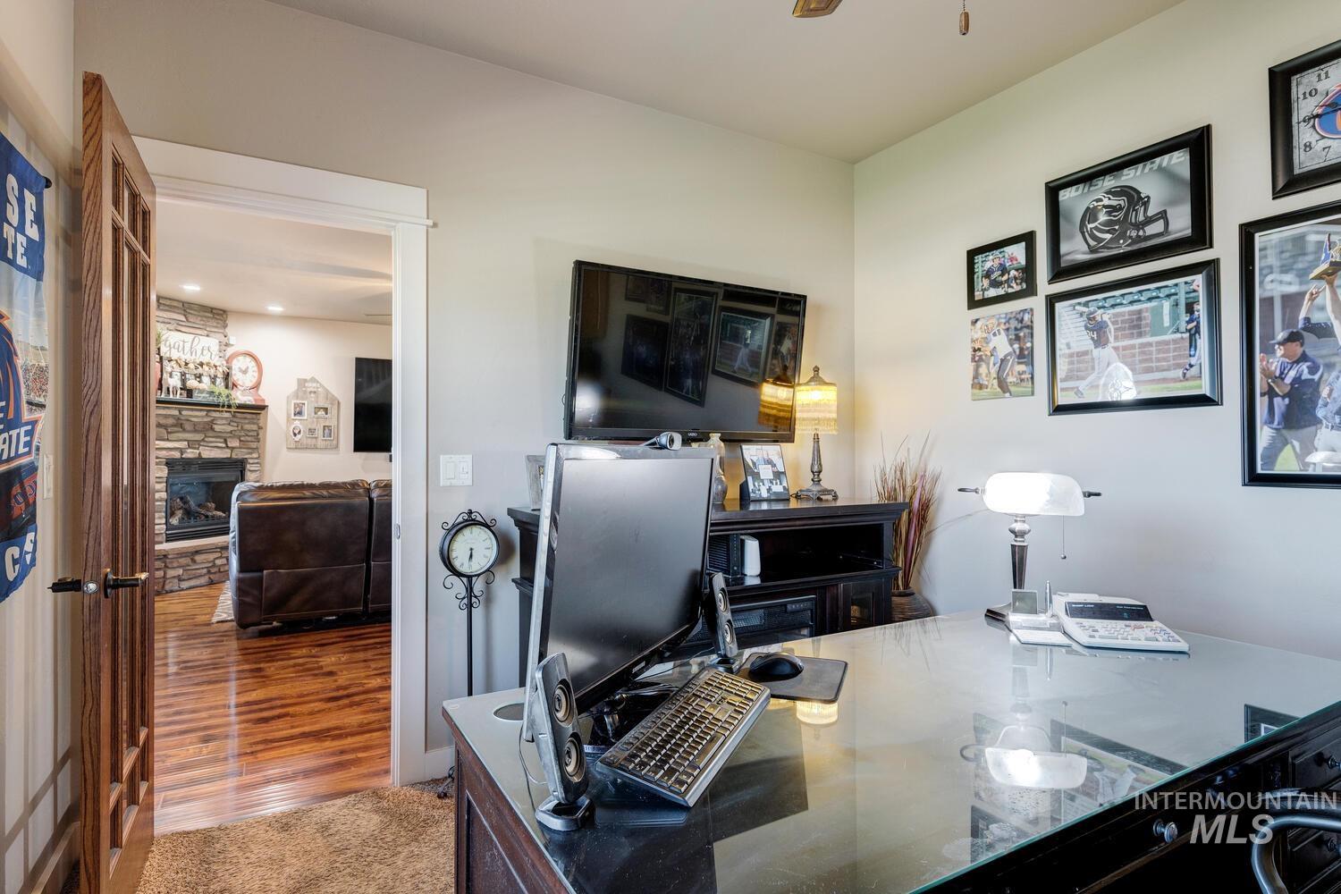 22757 Rosicky Way Caldwell, ID 83607 - Photo 25 of 50 Office with a fireplace and wood finished floors