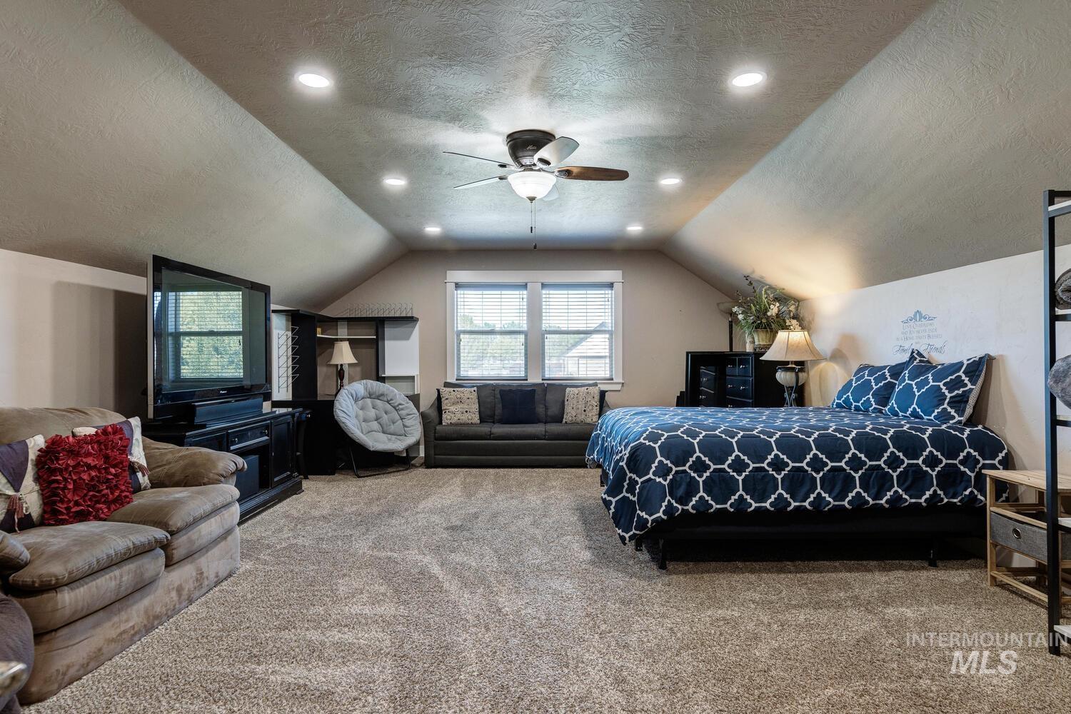 22757 Rosicky Way Caldwell, ID 83607 - Photo 28 of 50 Bedroom featuring a textured ceiling, vaulted ceiling, carpet floors, ceiling fan, and recessed lighting