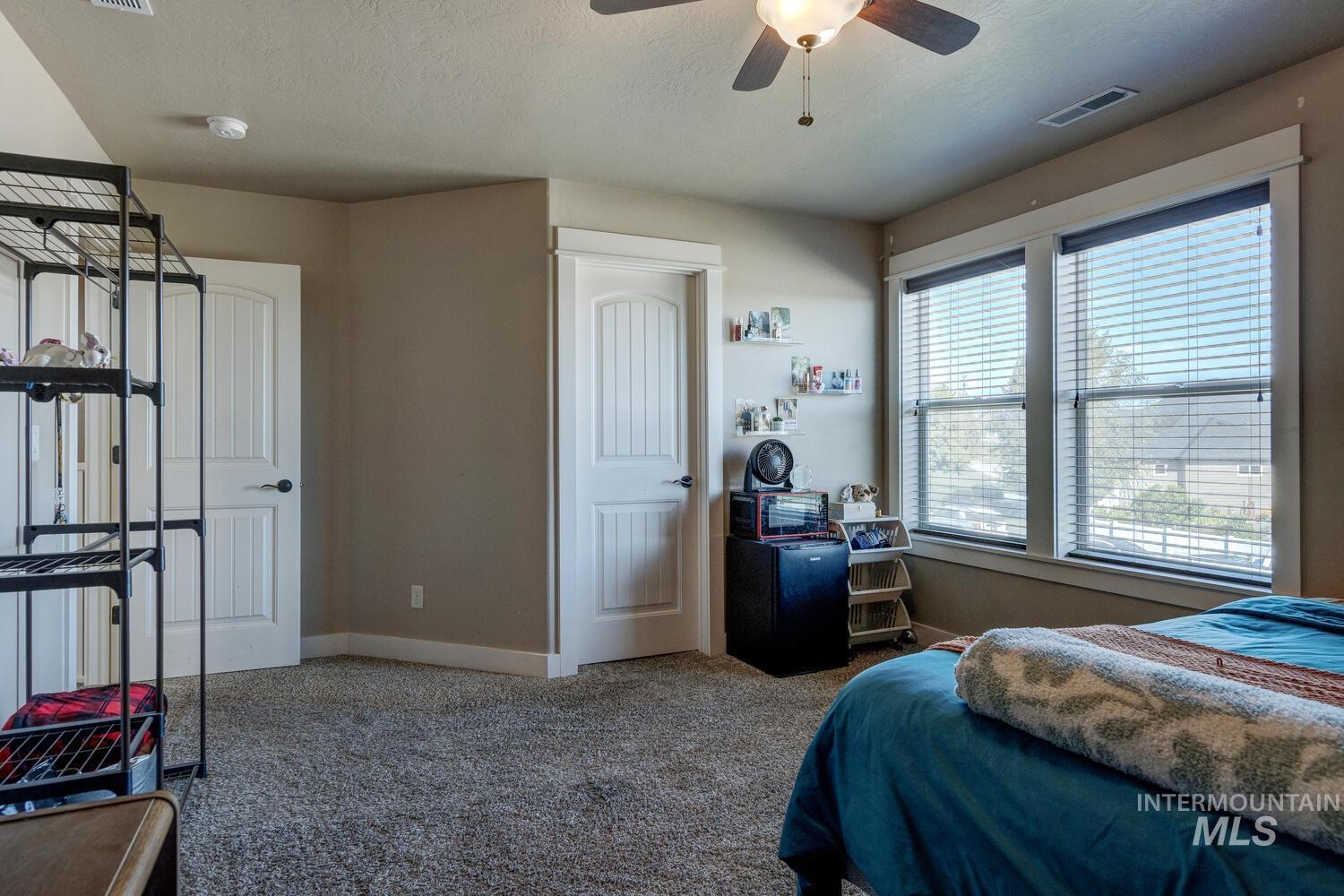 22757 Rosicky Way Caldwell, ID 83607 - Photo 31 of 50 Carpeted bedroom with a ceiling fan and a textured ceiling