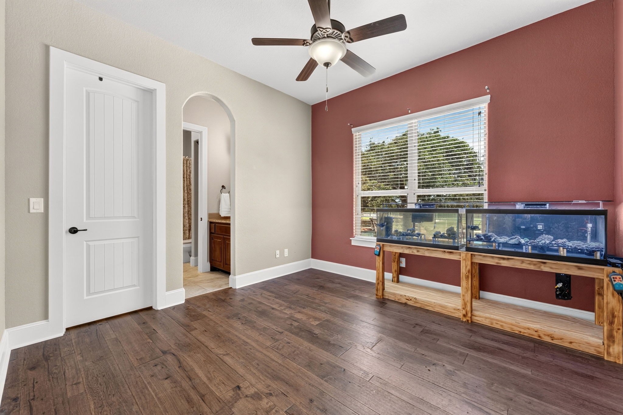 105 Coopers Hill Road Georgetown, TX 78633 - Photo 25 of 40 a view of a livingroom with wooden floor and a ceiling fan