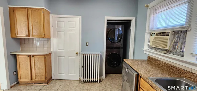 a kitchen with stainless steel appliances granite countertop a stove a refrigerator and a sink