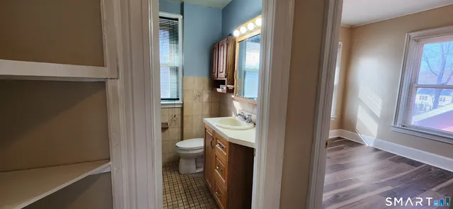 a bathroom with a toilet a sink and a shower