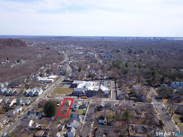 an aerial view of residential house with parking