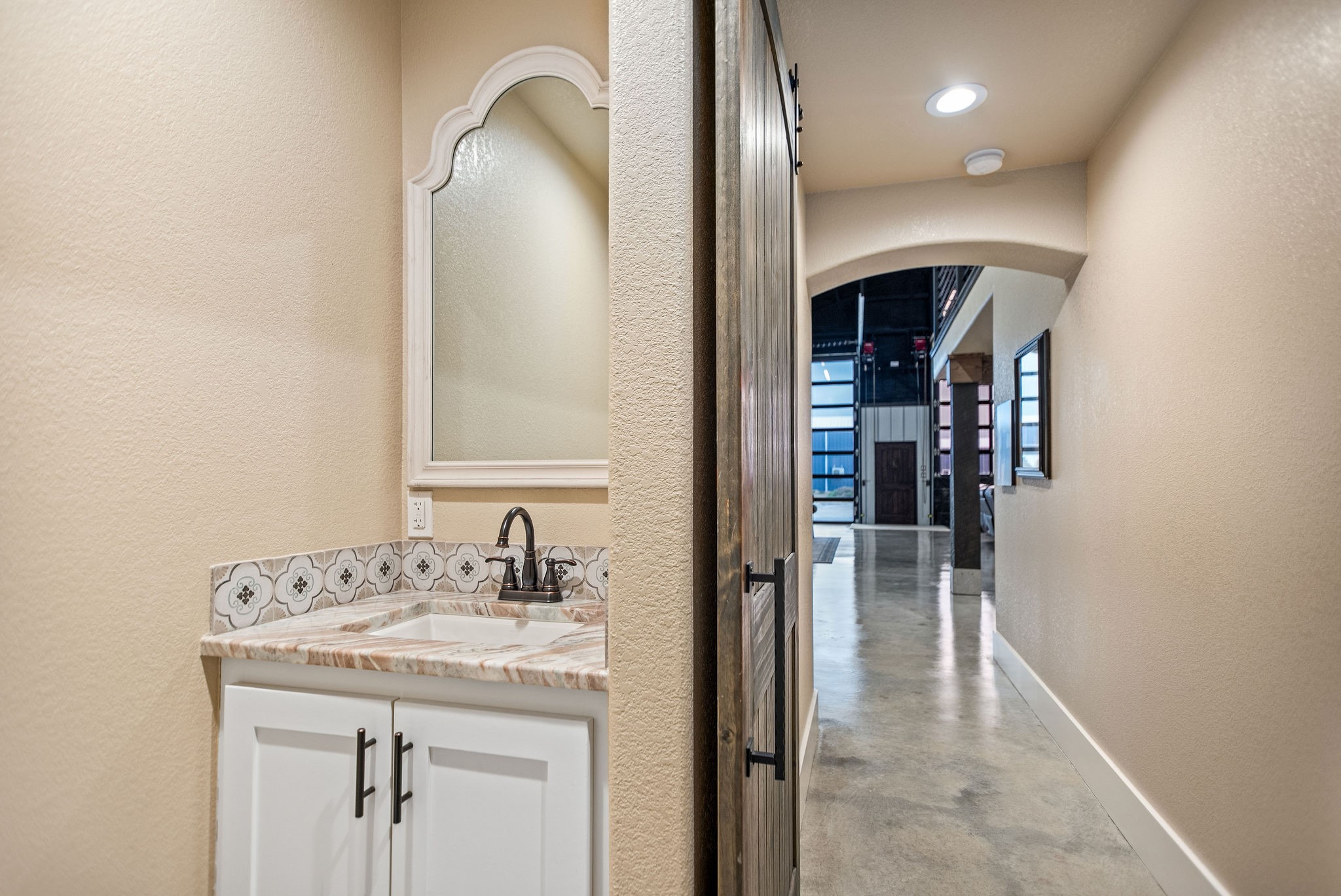 82 Circle Hook Port O'Connor, TX 77982 - Photo 18 of 32 a en suite bathroom with a granite countertop sink and a mirror