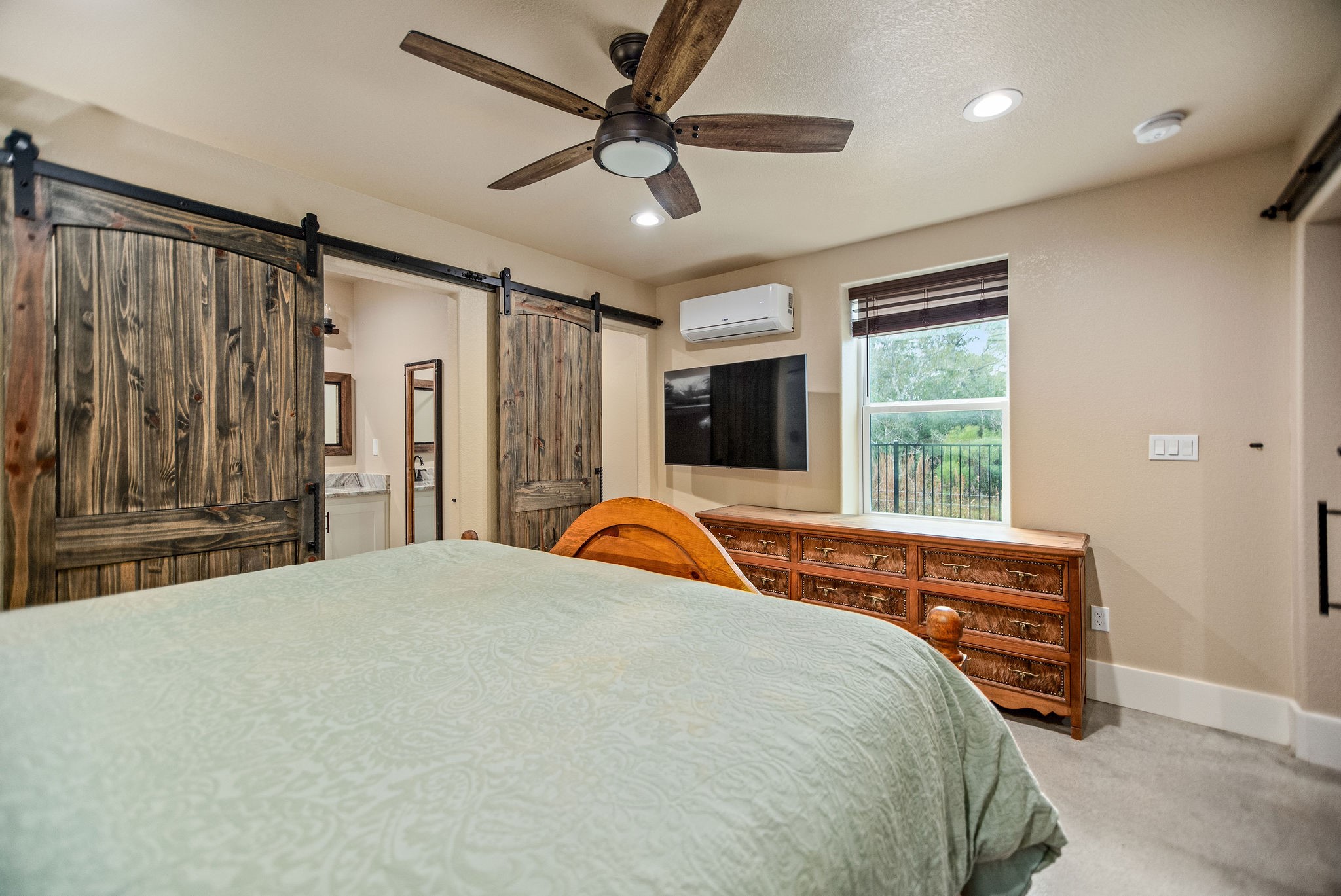82 Circle Hook Port O'Connor, TX 77982 - Photo 22 of 32 a bedroom with a bed dresser and a window