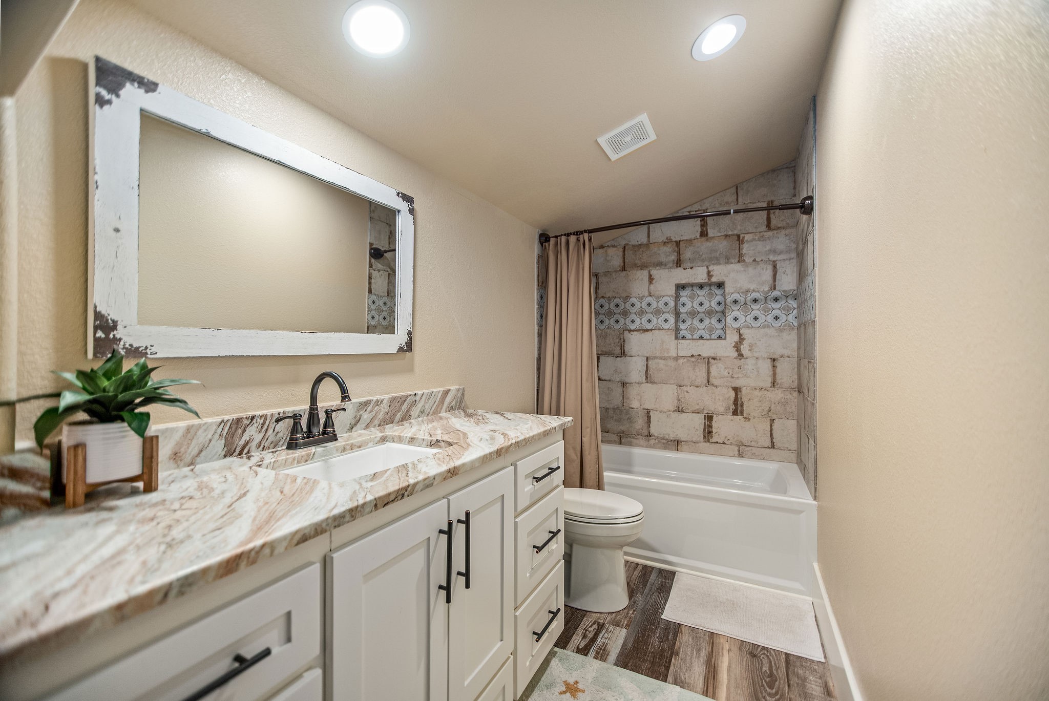 82 Circle Hook Port O'Connor, TX 77982 - Photo 28 of 32 a bathroom with a granite countertop sink a toilet a mirror a vanity and shower