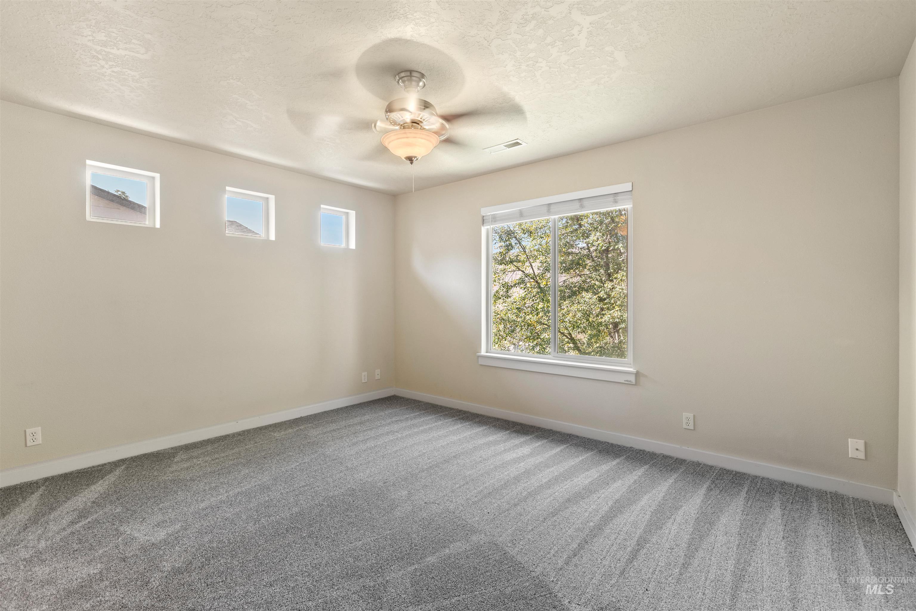 2209 South Amy Avenue Boise, ID 83706 - Photo 18 of 30 Carpeted spare room with a textured ceiling and a ceiling fan