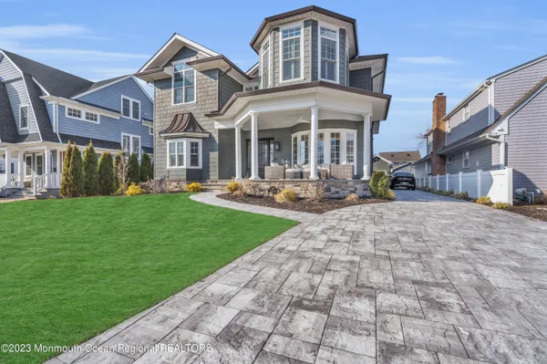 a front view of a house with a garden and plants