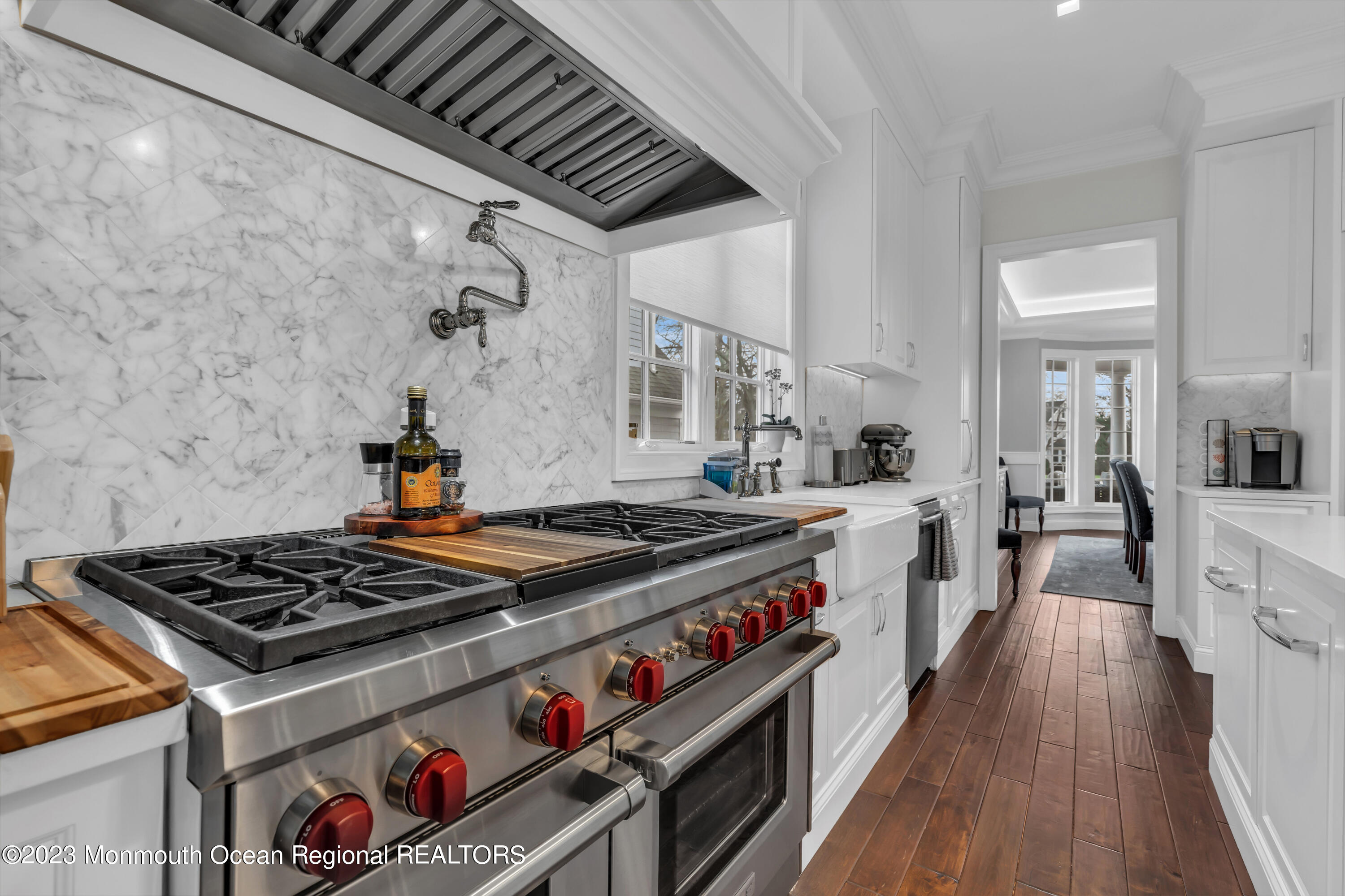 502 Brighton Avenue Spring Lake, NJ 07762 - Photo 19 of 78 a kitchen with a stove and wooden floor