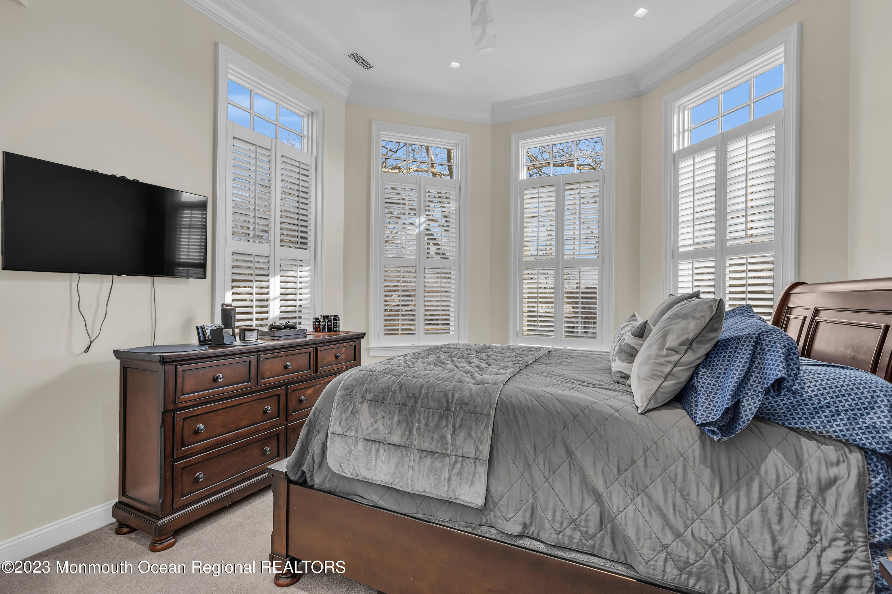 502 Brighton Avenue Spring Lake, NJ 07762 - Photo 29 of 78 a bedroom with a bed and flat screen tv