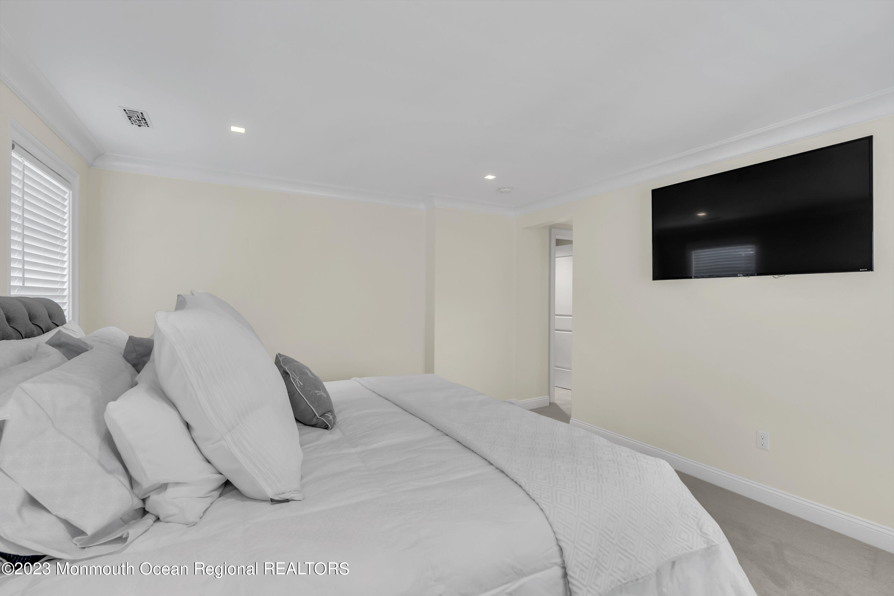 502 Brighton Avenue Spring Lake, NJ 07762 - Photo 41 of 78 a bedroom with a bed a flat screen tv and guitar