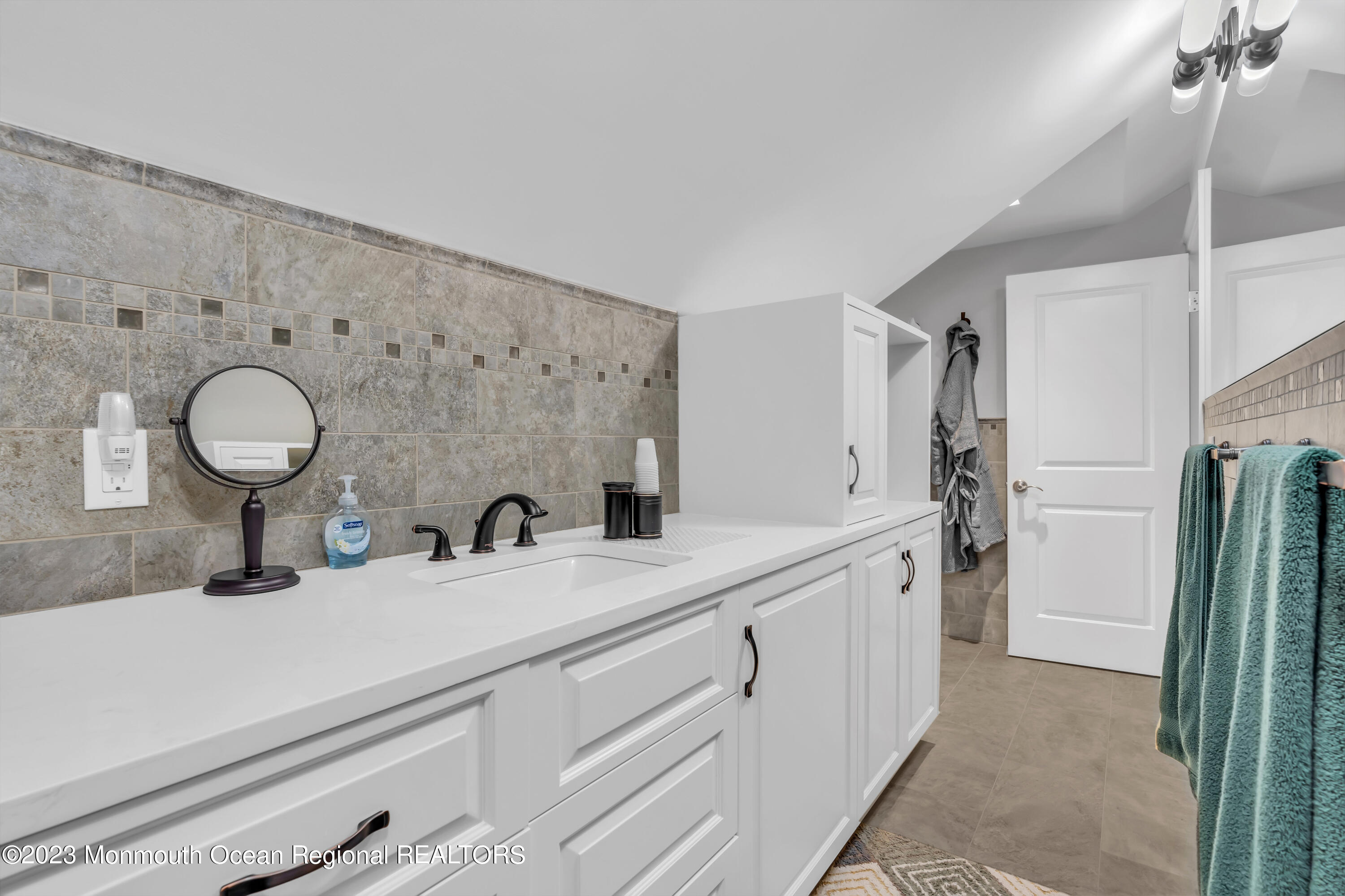 502 Brighton Avenue Spring Lake, NJ 07762 - Photo 46 of 78 a bathroom with a double vanity sink and mirror