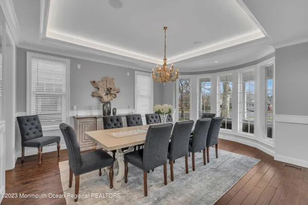 a living room with furniture kitchen view and a large window