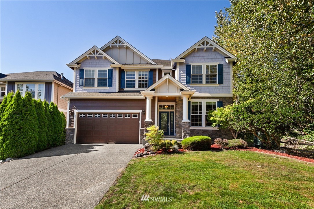 718 South 36th Place Renton, WA 98055 - Photo 1 of 40 a front view of a house with a yard and garage