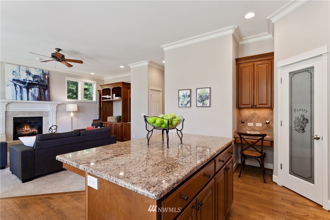 718 South 36th Place Renton, WA 98055 - Photo 13 of 40 a kitchen with granite countertop kitchen island stainless steel appliances a dining table and chairs