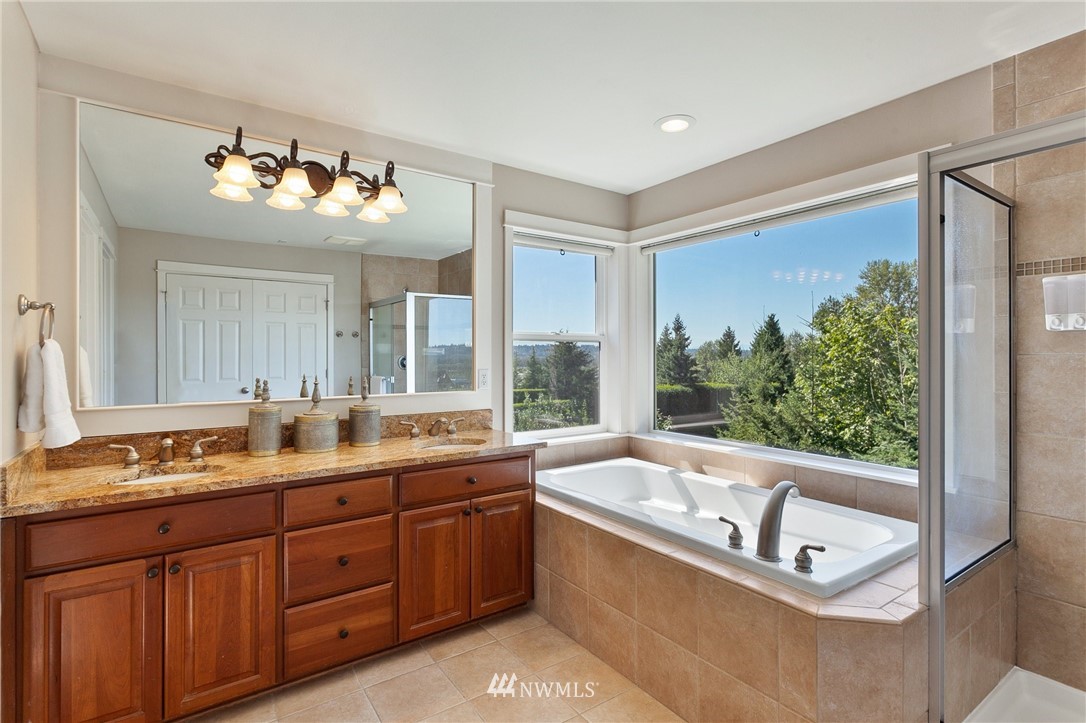 718 South 36th Place Renton, WA 98055 - Photo 22 of 40 a bathroom with a tub sink and mirror