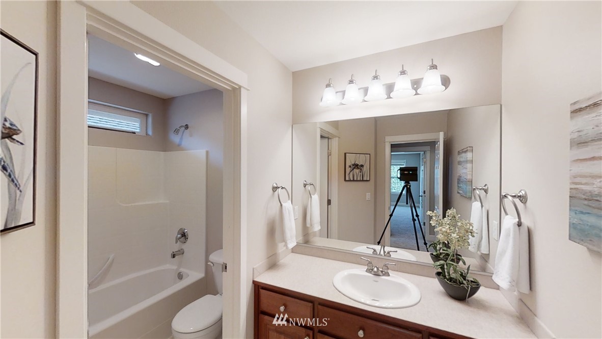 718 South 36th Place Renton, WA 98055 - Photo 34 of 40 a bathroom with a sink double vanity granite tub and a mirror