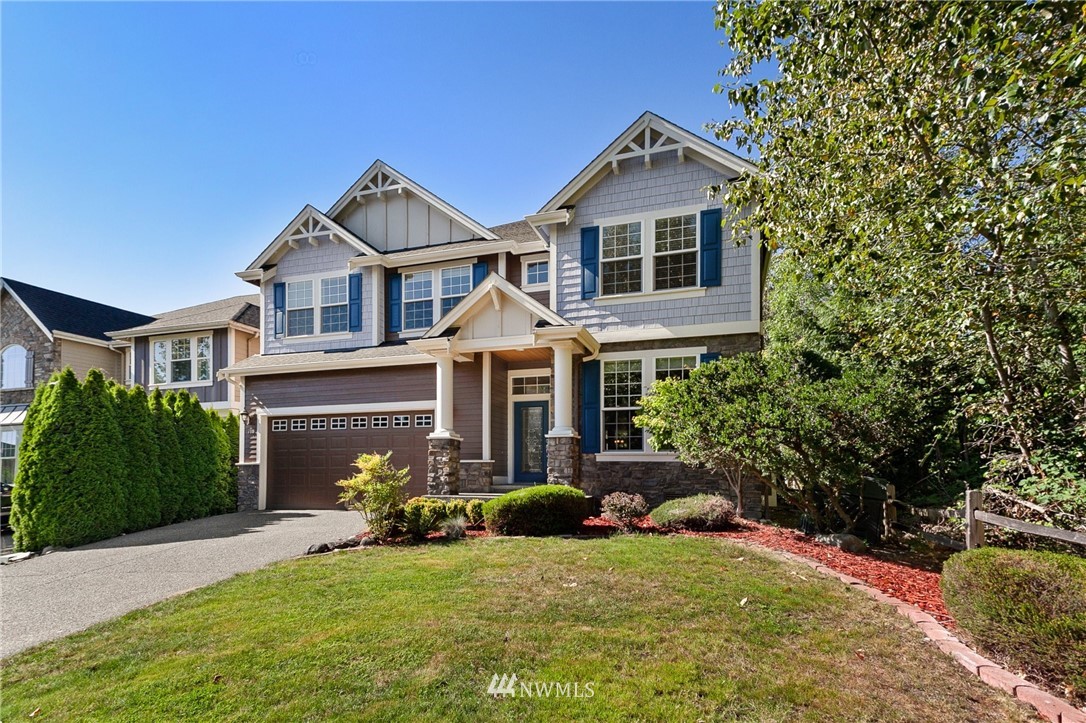 718 South 36th Place Renton, WA 98055 - Photo 39 of 40 a front view of a house with garden
