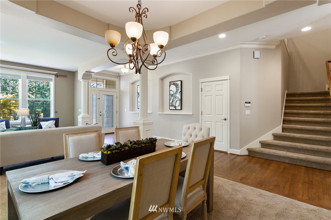 718 South 36th Place Renton, WA 98055 - Photo 5 of 40 a view of a dining room with furniture a chandelier and large windows