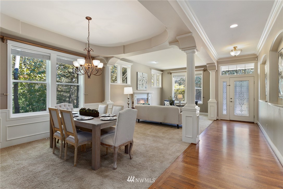 718 South 36th Place Renton, WA 98055 - Photo 6 of 40 a view of a dining room and livingroom with furniture wooden floor a chandelier